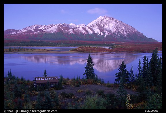 Mountains and lake at dusk, cabin with Denali sign. Alaska, USA