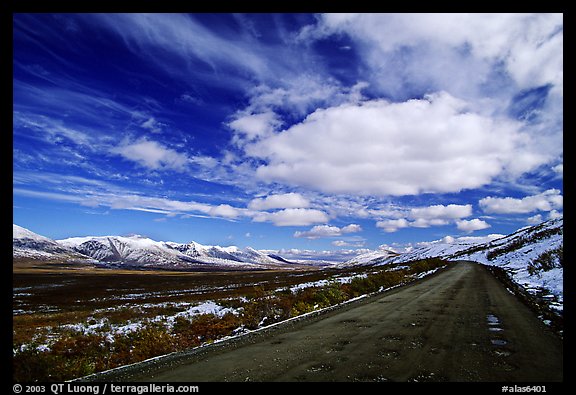 Denali Highway under large white clouds. Alaska, USA (color)