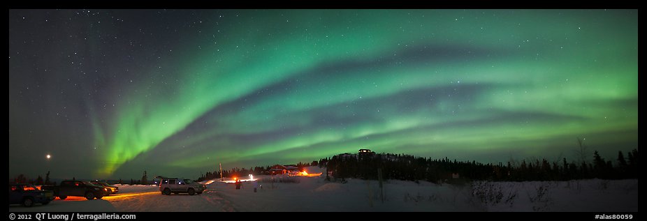 Northern Lights streaking above cars and cabin at Cleary Summit. Alaska, USA (color)