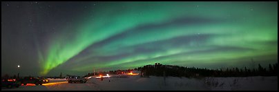 Northern Lights streaking above cars and cabin at Cleary Summit. Alaska, USA (color)