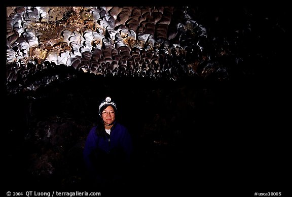 Caver inside a lava tube, Lava Beds National Monument. Lava Beds National Monument, California, USA (color)