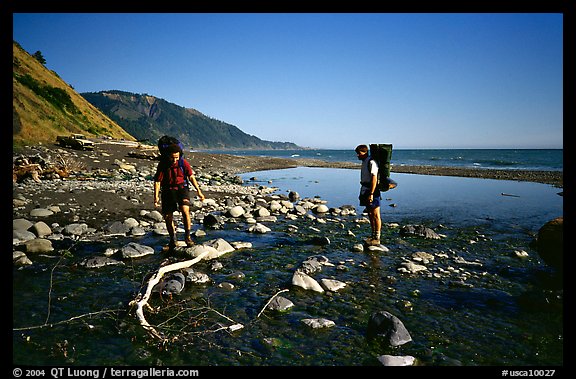 Backpackers cross a stream, Lost Coast. California, USA