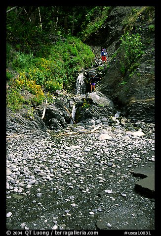 Hikers exploring a cascade, Lost Coast. California, USA