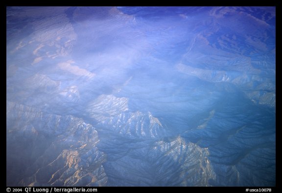 Aerial view of desert mountains with thin clouds. California, USA