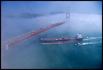 Tanker ship cruising under the Golden Gate Bridge in the fog. San Francisco, California, USA (color)