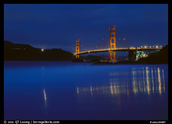 Golden Gate Bridge reflected in wet sand, blue hour. San Francisco, California, USA (color)