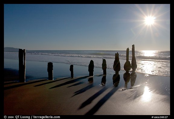 Row of wood pilars and sun near Fort Funston,  late afternoon, San Francisco. San Francisco, California, USA (color)