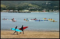 Surfers and sea kayakers, Pillar point harbor. Half Moon Bay, California, USA