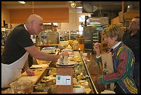 Choosing cheese at the Cheese Board. Berkeley, California, USA