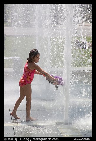 Girl refreshing herself, Cesar de Chavez Park. San Jose, California, USA (color)