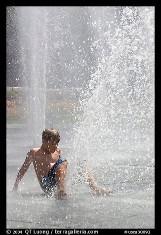 Boy playing in water,  Cesar de Chavez Park. San Jose, California, USA