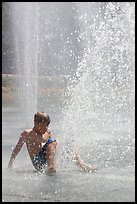 Boy playing in water,  Cesar de Chavez Park. San Jose, California, USA (color)