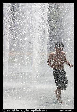 Boy refreshing himself  Cesar de Chavez Park. San Jose, California, USA