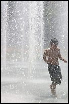 Boy refreshing himself  Cesar de Chavez Park. San Jose, California, USA (color)