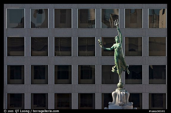 Statue on Admiral Dewey memorial column in front of modern building. San Francisco, California, USA