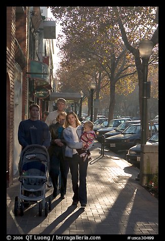 Family strolls on the sidewalk of University Avenue. Palo Alto,  California, USA (color)