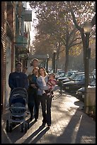 Family strolls on the sidewalk of University Avenue. Palo Alto,  California, USA ( color)