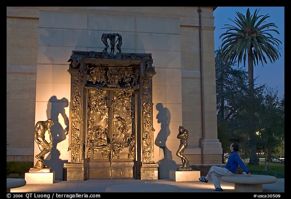 Visitor contemplating Rodin's Gates of Hell in the Rodin sculpture garden. Stanford University, California, USA