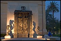 Visitor contemplating Rodin's Gates of Hell in the Rodin sculpture garden. Stanford University, California, USA