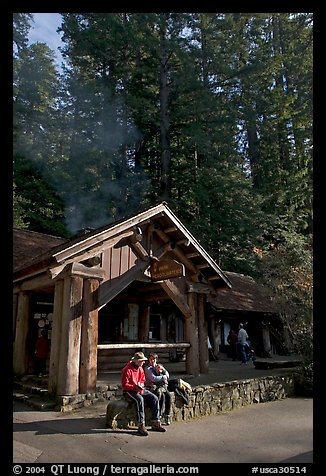 Couple sitting in front of park headquarters, afternoon. Big Basin Redwoods State Park,  California, USA (color)