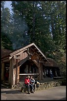 Couple sitting in front of park headquarters, afternoon. Big Basin Redwoods State Park,  California, USA