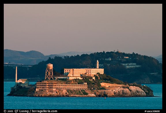 Alcatraz Island at sunset, with Yerba Buena Island in the background. San Francisco, California, USA