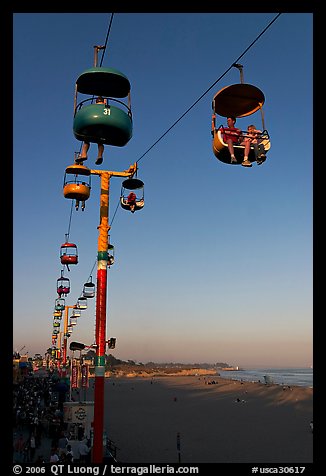 Sky glider Riders enjoy the last sunrays of the day. Santa Cruz, California, USA