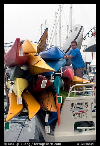 Sea Kayaks attached to a tour boat. California, USA (color)