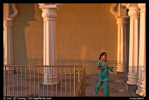 Indian girl running in the Sikh Gurdwara Temple, late afternoon. San Jose, California, USA