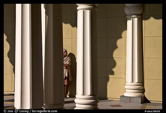 Woman and colonade, Sikh Gurdwara Temple. San Jose, California, USA