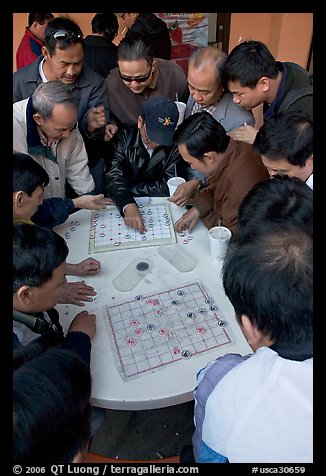 Vietnamese immigrants playing Chinese chess in a patio. San Jose, California, USA