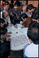 Vietnamese immigrants playing Chinese chess in a patio. San Jose, California, USA ( color)