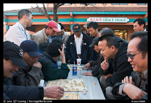 Vietnamese immigrants at a Chinese chess game. San Jose, California, USA (color)