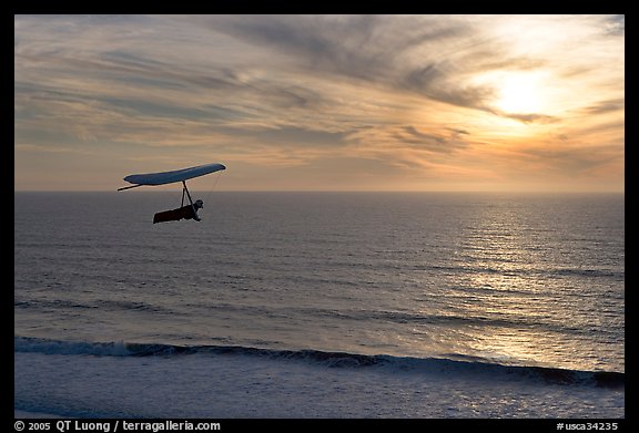 Hang gliding above the ocean at sunset,  Fort Funston. San Francisco, California, USA (color)