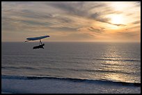 Hang gliding above the ocean at sunset,  Fort Funston. San Francisco, California, USA