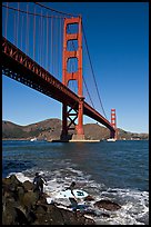 Surfers below the Golden Gate Bridge. San Francisco, California, USA