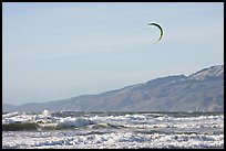 Kite surfer in Pacific Ocean waves, afternoon. San Francisco, California, USA (color)