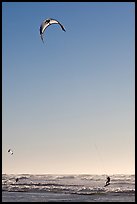 Kite surfing in Pacific Ocean waves, late afternoon. San Francisco, California, USA