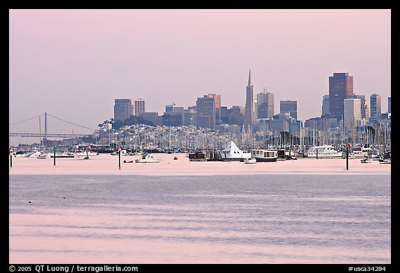 Alcatraz Island and Bay Bridge, painted in pink hues at sunset. San Francisco, California, USA