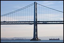 Traffic on Oakland Bay Bridge and tanker ship. San Francisco, California, USA