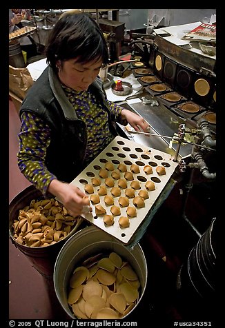 Fortune cookies being folded with great dexterity, Chinatown. San Francisco, California, USA (color)