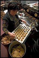 Fortune cookies being folded with great dexterity, Chinatown. San Francisco, California, USA ( color)