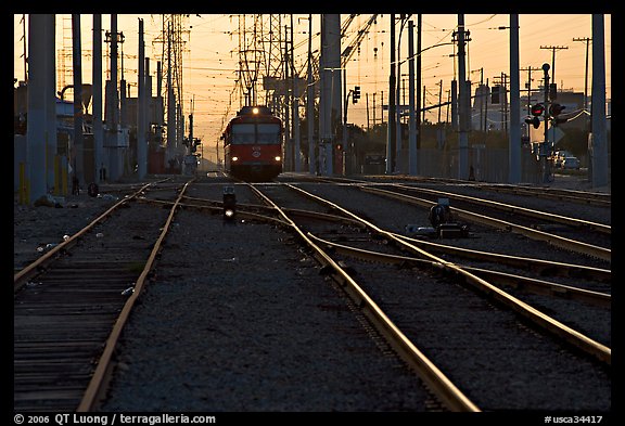 Railroad tracks, train, and power lines, sunrise. San Diego, California, USA (color)