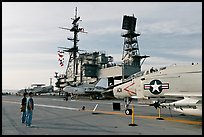 Couple looking at fighter aircraft on the Flight deck of USS Midway. San Diego, California, USA