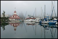 Boats and historic Coronado boathouse in fog. San Diego, California, USA