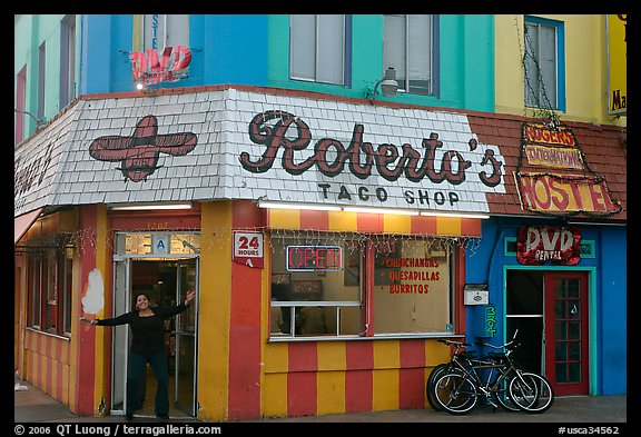 Woman exiting taco shop, Pacific Beach. San Diego, California, USA (color)