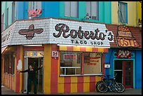 Woman exiting taco shop, Pacific Beach. San Diego, California, USA ( color)