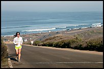 Woman jogging on raod,  Torrey Pines State Preserve. La Jolla, San Diego, California, USA (color)