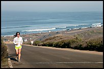 Woman jogging on raod,  Torrey Pines State Preserve. La Jolla, San Diego, California, USA (color)