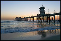 Huntington Pier reflected in wet sand at sunset. Huntington Beach, Orange County, California, USA ( color)